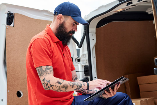 Worker checking cargo list at the truck.