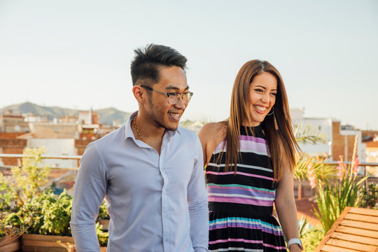Man and Woman Smiling on Rooftop