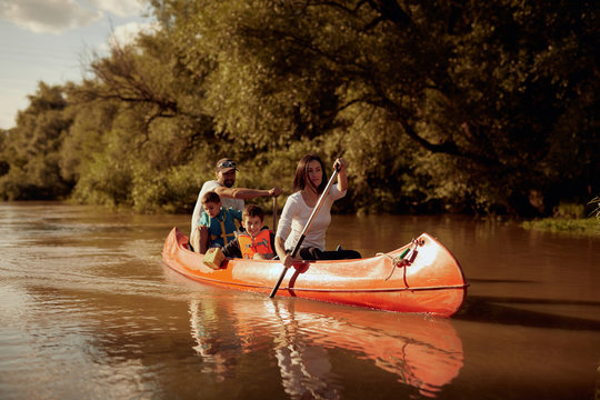 Family canoeing in river