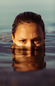 Close up young woman in water