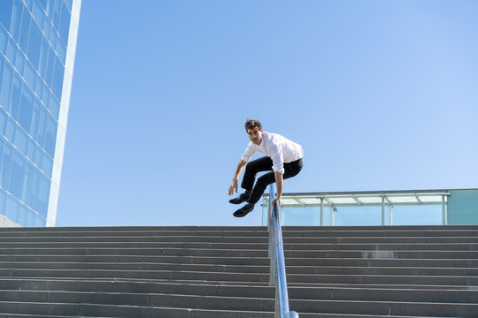 Businessman crossing banister in the city