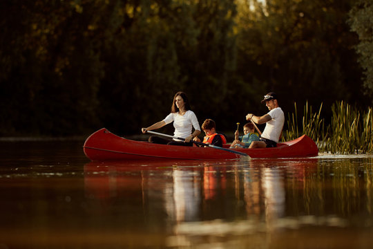 Family canoeing in river