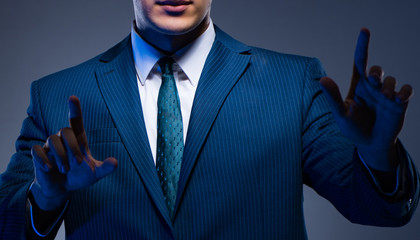 Businessman pressing virtual buttons on gray background