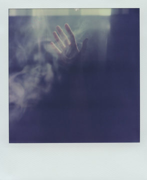 Crop hand in light and smoke