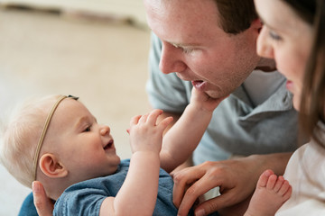 Family: Parents Lovingly Play With Baby Girl