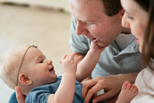 Family: Parents Lovingly Play With Baby Girl