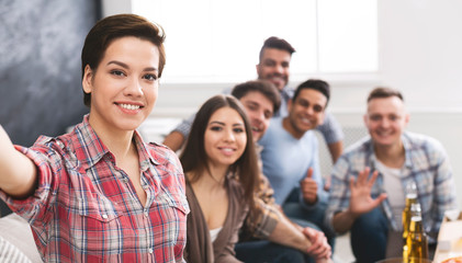 Girl taking selfie with her multiethnical friends