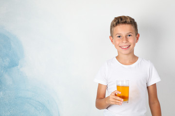 Smile boy with sweet cocktail against white background