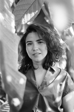 A beautiful portrait of a young woman in a greenhouse