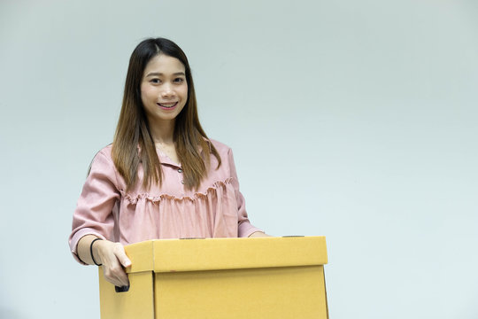 Beautiful young asian woman with cardboard box in his hand