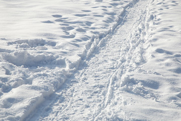 Fototapeta na wymiar Trampled path for walking pedestrians in a snowbound winter city