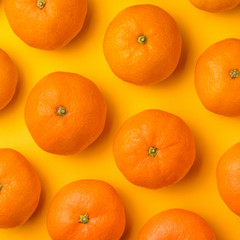 Fruit pattern of mandarin on yellow background. Tangerine. Flat lay, top view.