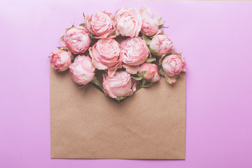 Envelope of craft paper with pink roses. Congratulation with wedding, birthday, valentines day.