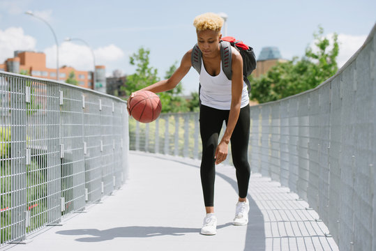Woman dribbling basketball