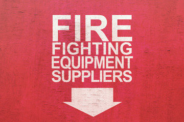 The inscription "Fire fighting equipment suppliers" on a red wooden board