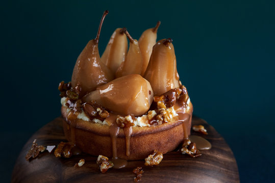 Homemade poached pear topped cake with salted caramel sauce