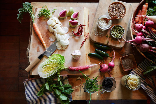 Various vegetables on cutting boards and kitchen island.