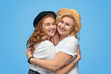 Stylish mother and daughter embracing each other