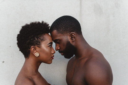 Close up portrait of young black couple facing each other