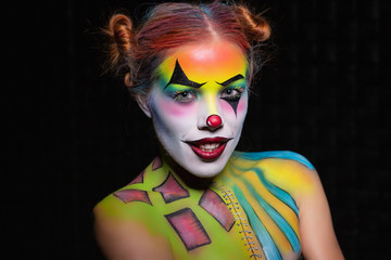 Cute woman with a body art clown.