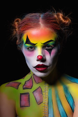 Attractive woman with a body art clown.