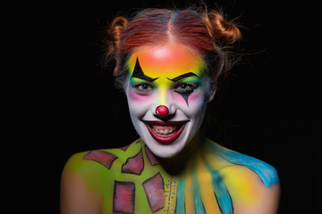 Cheeful woman with a body art clown.