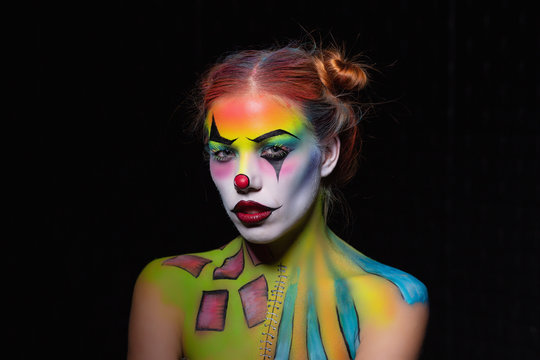 Lovely woman with a body art clown.