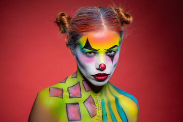 Nice young lady with a face painting clown.