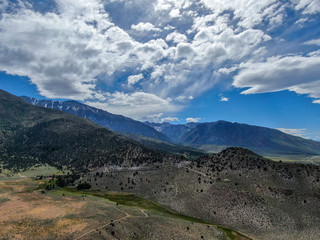 Fototapeta na wymiar Aerial top view of green land and mountain in the background in Aspen Springs, Mono County California, USA