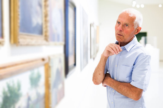 Man observing painting gallery