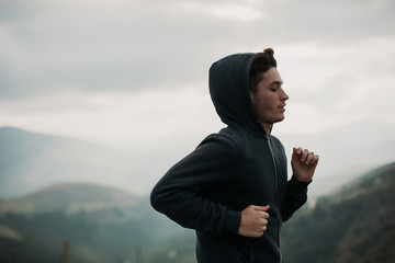 Side view of man jogging outdoors