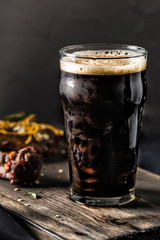 Dark beer in a steamed glass and grilled pork ribs