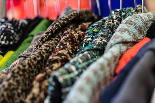 close up of winter coats on a rack