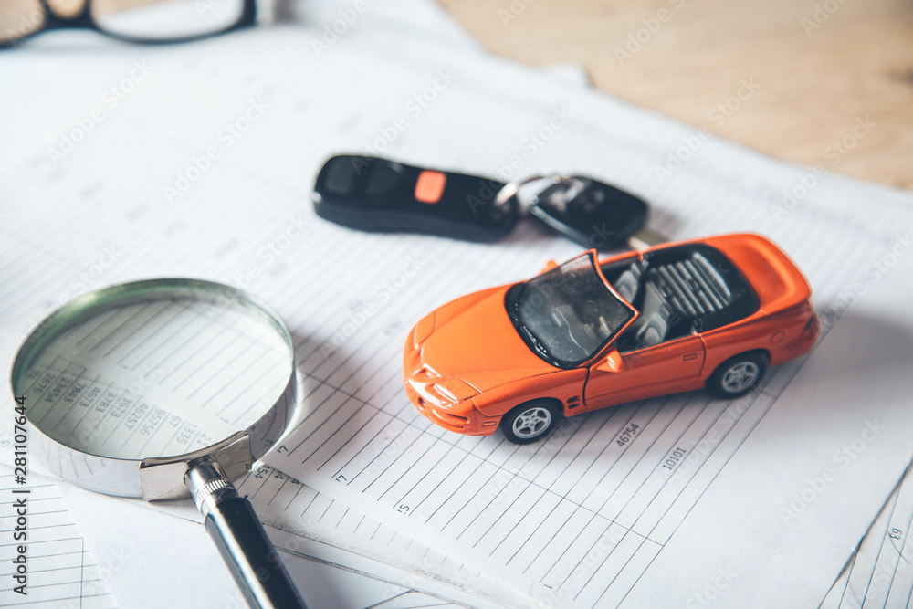 Poster magnifier with key and car model on document