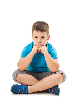 Sulky angry young boy child, sulking and pouting. Isolated on white background
