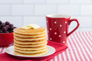 A Stack of Freshly Made Pancakes on a Gingham Tablecloth