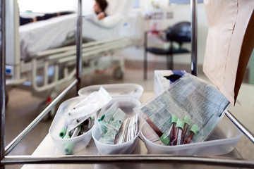 Blood collection tubes on a trolley in a hospital room