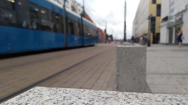 tram in the old town, the rails between the pavers. heavy city traffic and sidewalks, pedestrians and cyclists. traffic safety