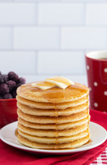 A Stack of Freshly Made Pancakes on a Gingham Tablecloth