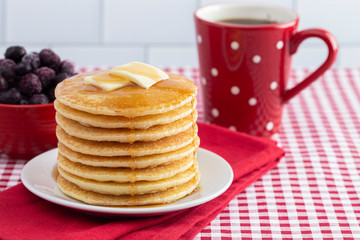 A Stack of Freshly Made Pancakes on a Gingham Tablecloth