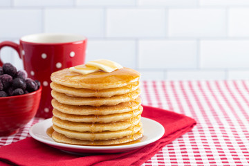 A Stack of Freshly Made Pancakes on a Gingham Tablecloth