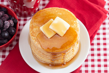 A Stack of Freshly Made Pancakes on a Gingham Tablecloth