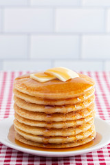 A Stack of Freshly Made Pancakes on a Gingham Tablecloth