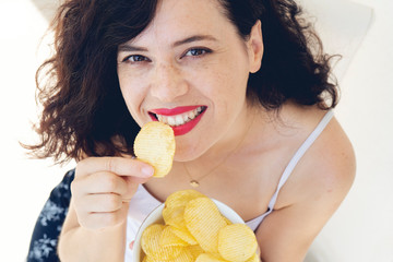 A girl holding the big potato chips bowl. Asking to eating together, Happiness sharing concept.
