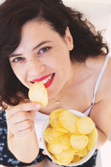 A girl holding the big potato chips bowl. Asking to eating together, Happiness sharing concept.