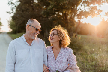 Stylish Senior couple walking in nature
