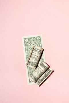 US Dollar Bills On Pink Background