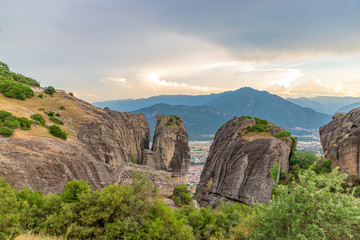 Wonderful view of the rocks and monasteries of Meteora, Greece. Mysterious Sunny evening with colorful sky, during sunset. Awesome Nature Landscape. Amazing Greece. Popular travel locations