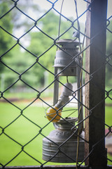 old light lamp in the garden behind the net with shallow depth of field 