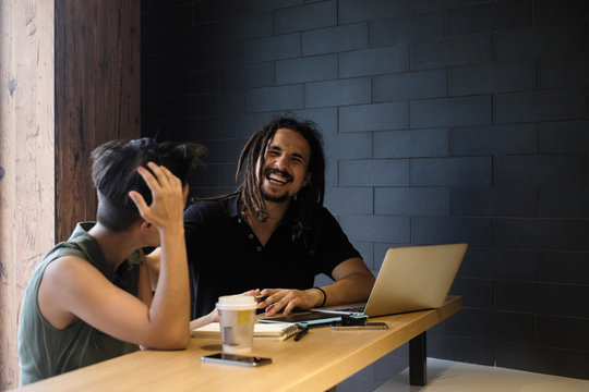 Young people work with laptop in cafe